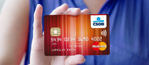 Woman holding blank credit card in hand