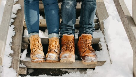 The crop photo of young couple at the nature park in cold season. Travel adventure love story